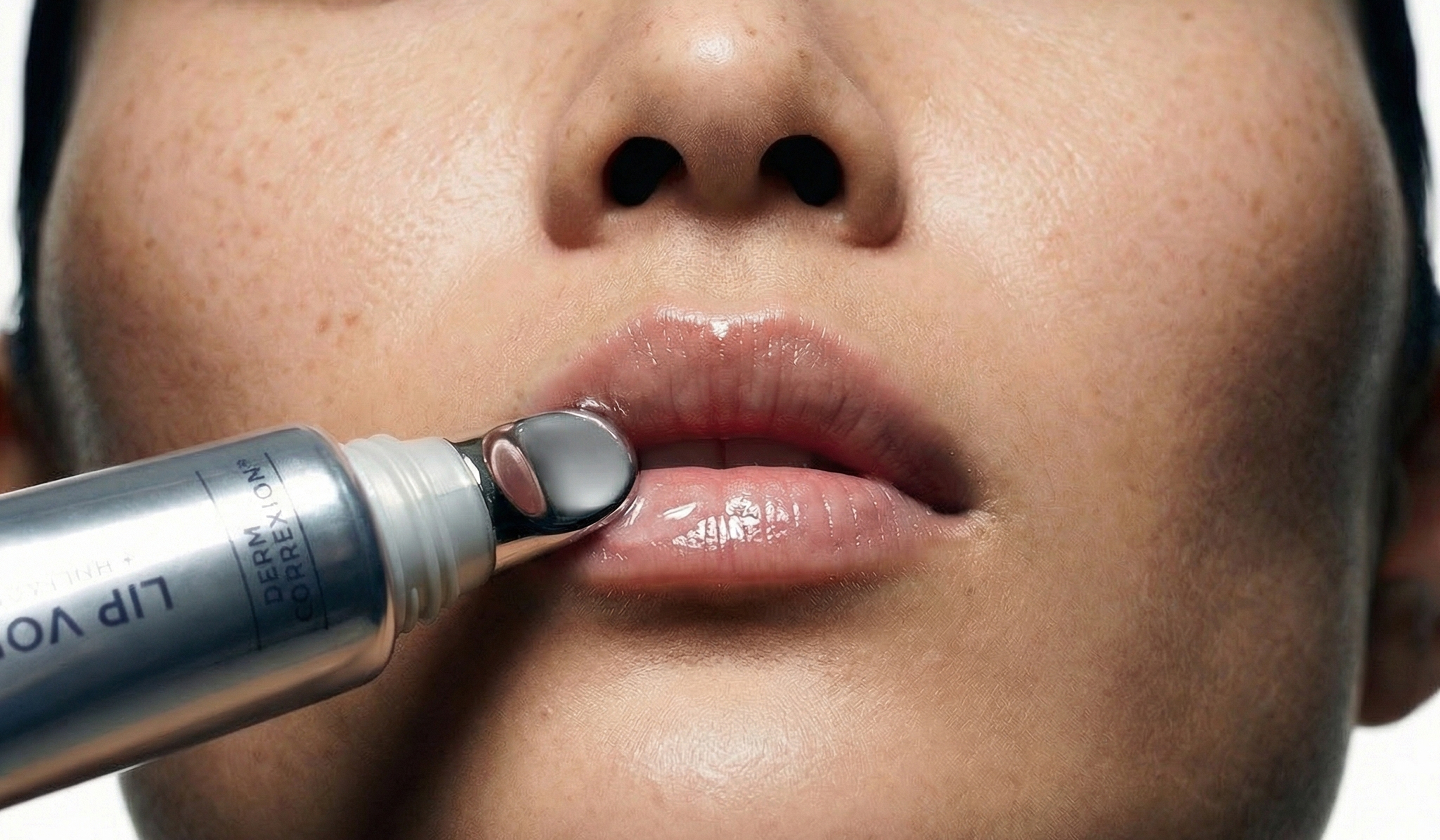 Macro close-up of lip gloss applicator